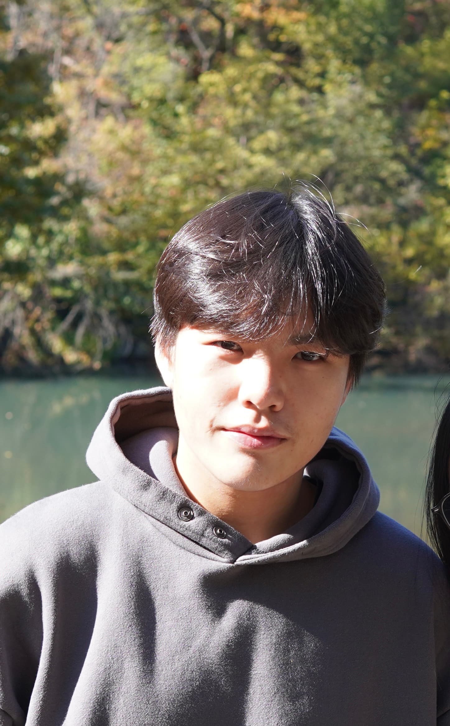 Quan outdoors beside a lake